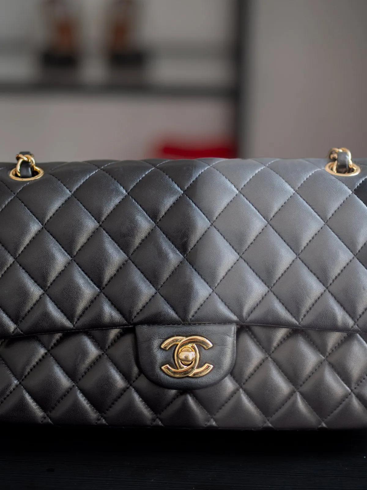 Chanel quilted handbag half restored, showing the before and after at WhizzFix Malta