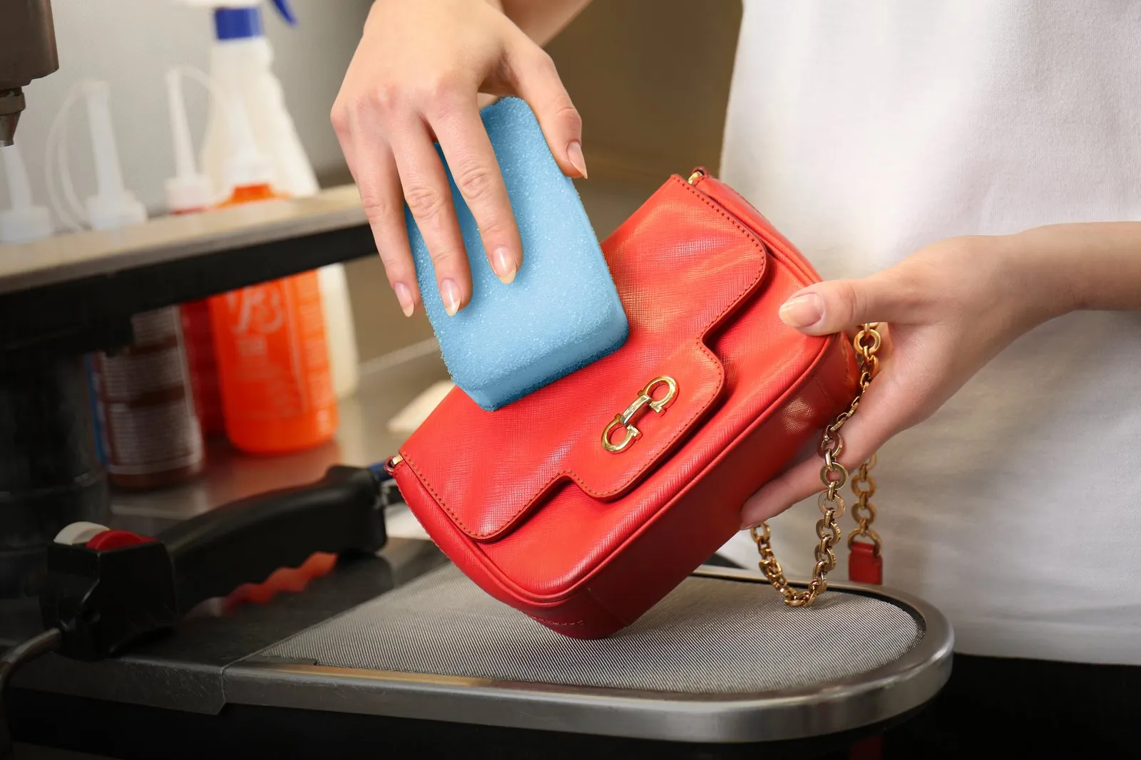 Leather handbag being cleaned by hand at WhizzFix handbag restoration in Malta