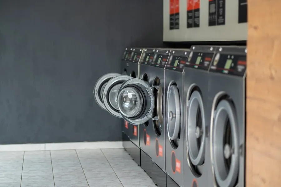 Row of commercial washing machines at the WhizzFix self-service laundry in St Julian's