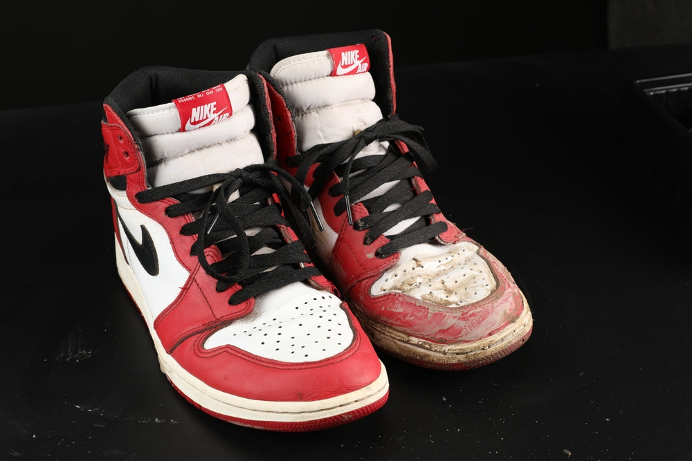 before and after comparison of a cleaning on a red pair of nike high top shoes
